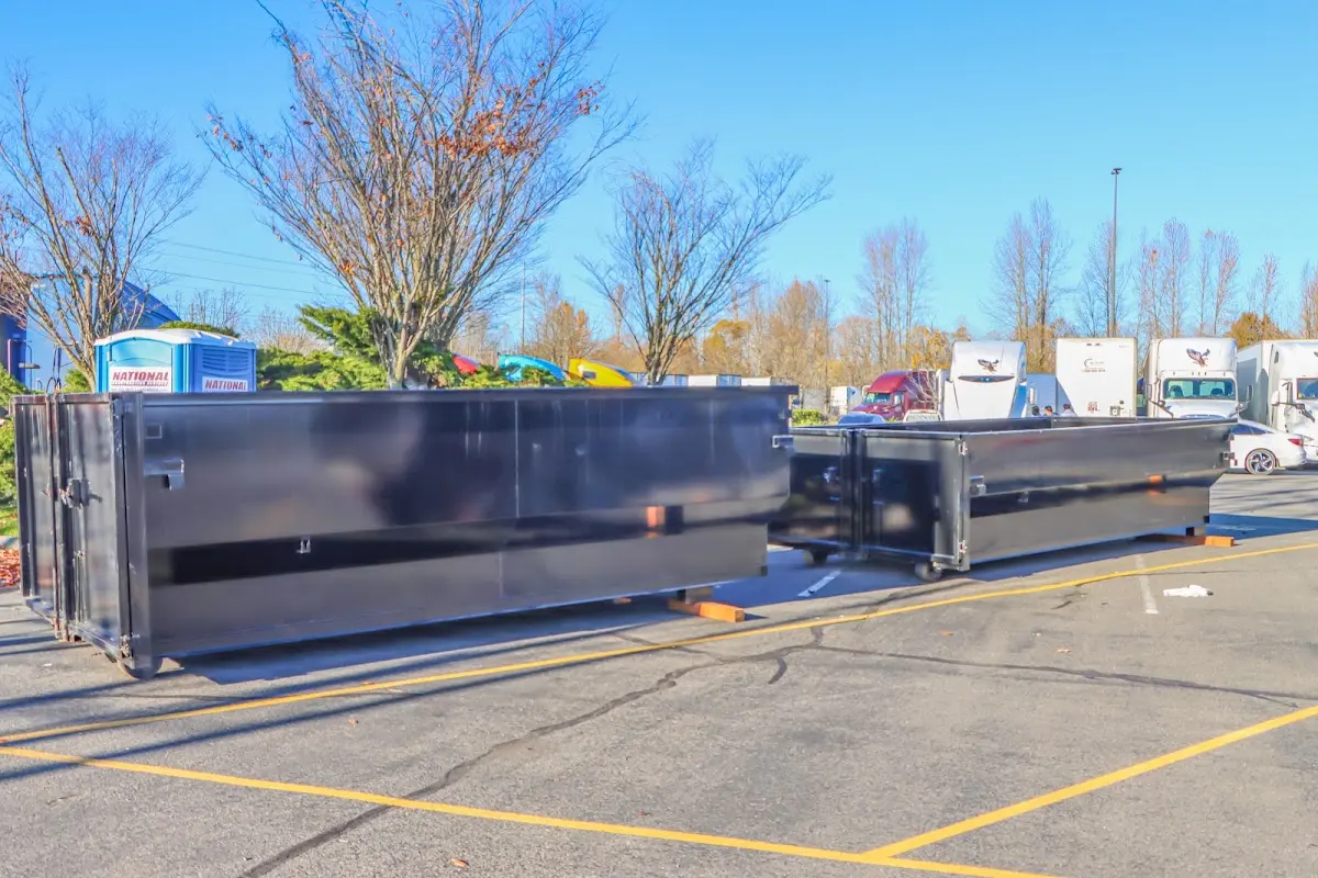 Professional dumpster rental service with roll-off container on residential driveway in Birch Run